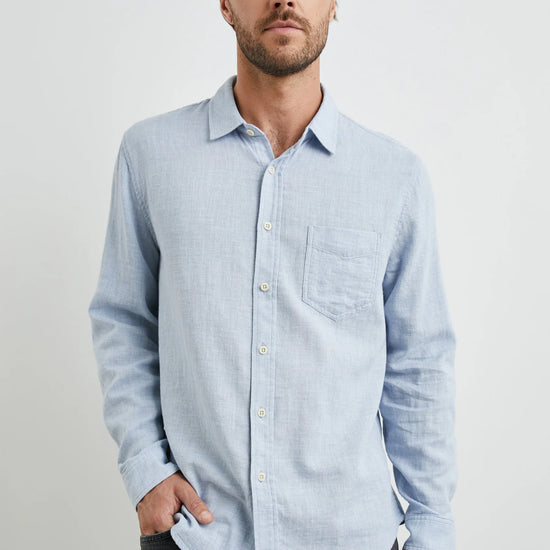 light blue shirt with chest pocket and curved hem