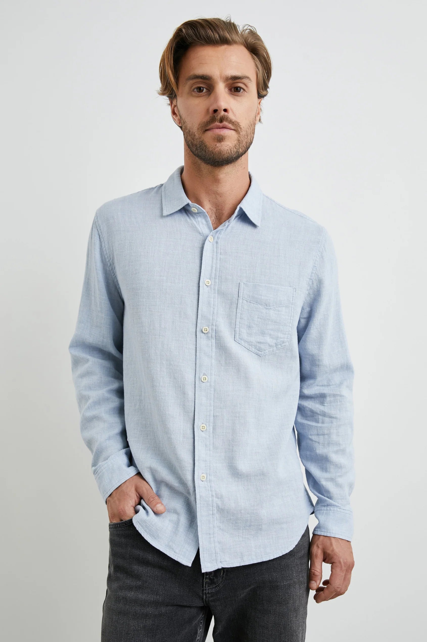 light blue shirt with chest pocket and curved hem