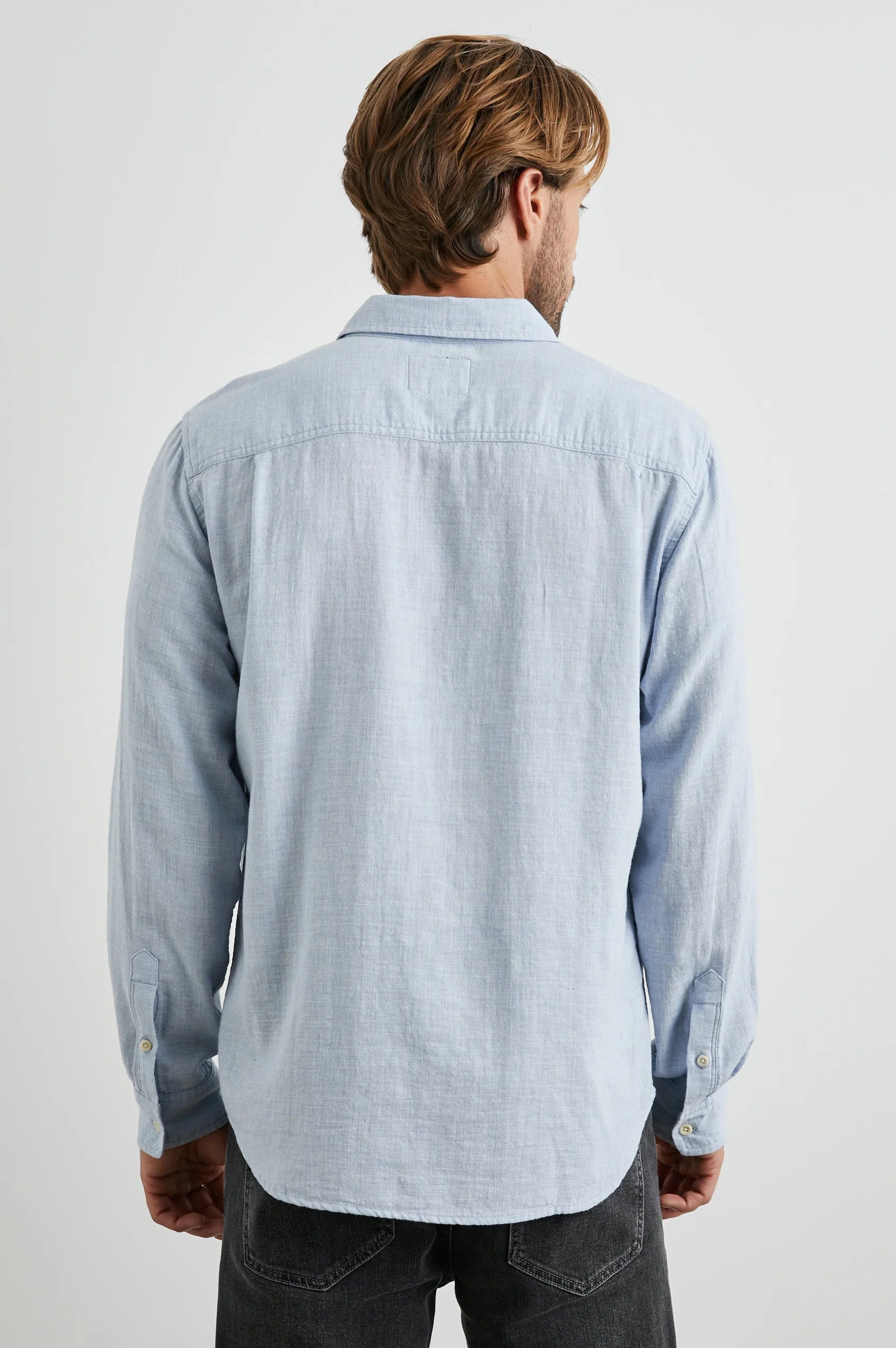 light blue shirt with chest pocket and curved hem rear view 