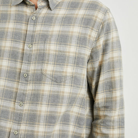 grey check shirt with chest pocket and curved hem  close up