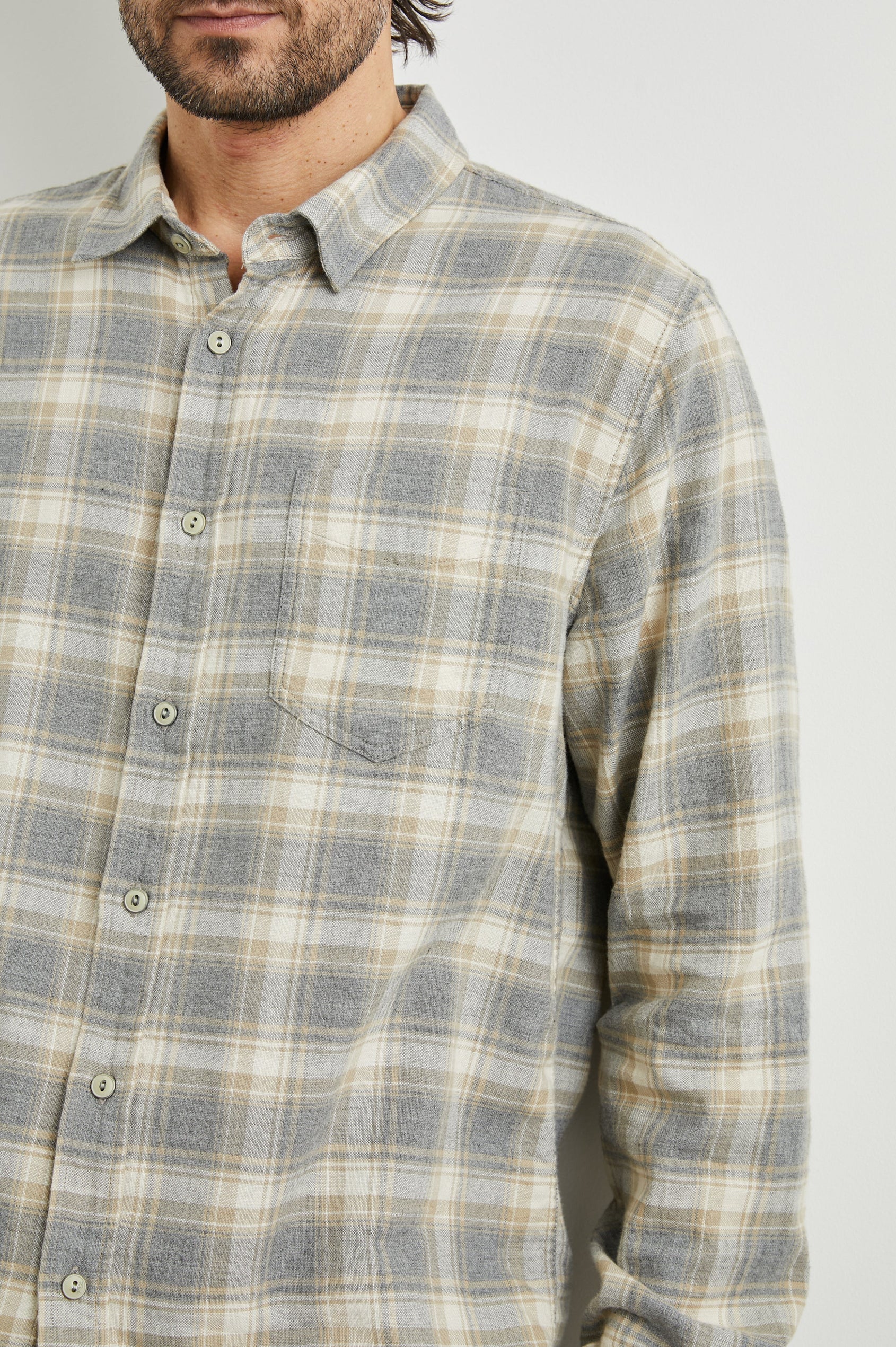 grey check shirt with chest pocket and curved hem  close up