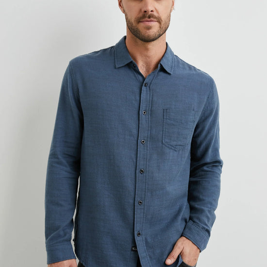 blue shirt with chest pocket and curved hem 