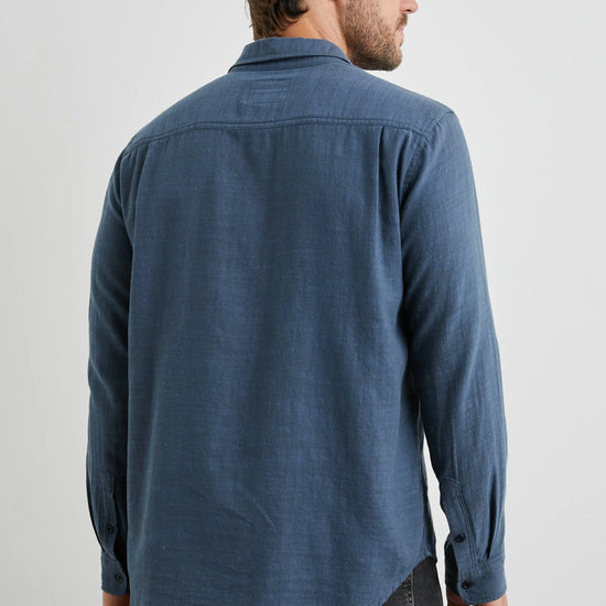 blue shirt with chest pocket and curved hem rear view 