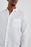 white shirt with chest pocket and curved hem close up