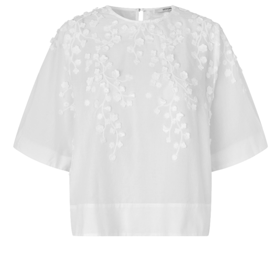 White blouse with floral embroidery on a white background
