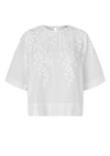 White blouse with floral embroidery on a white background