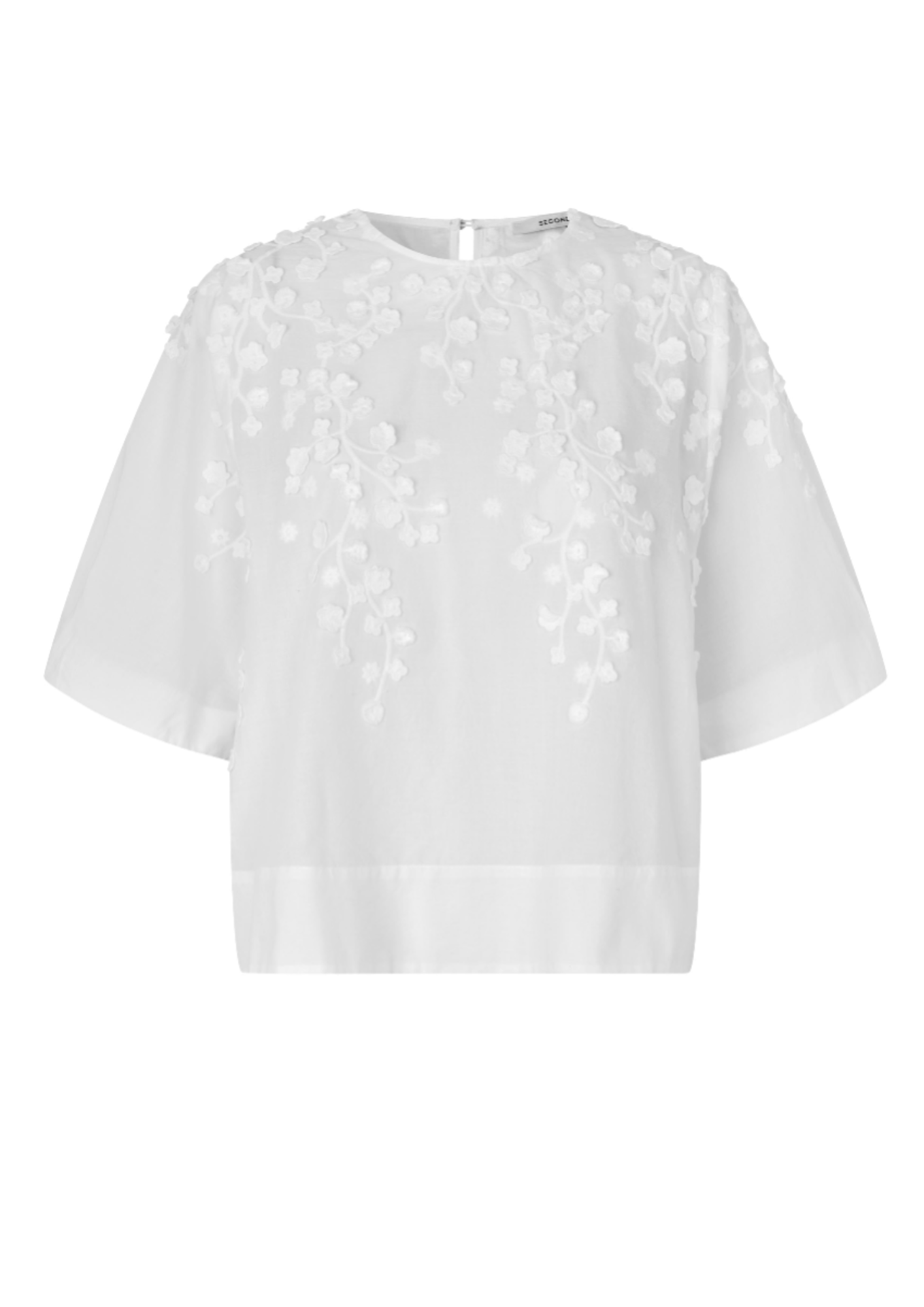White blouse with floral embroidery on a white background