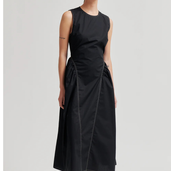 model wearing black sculptured dress