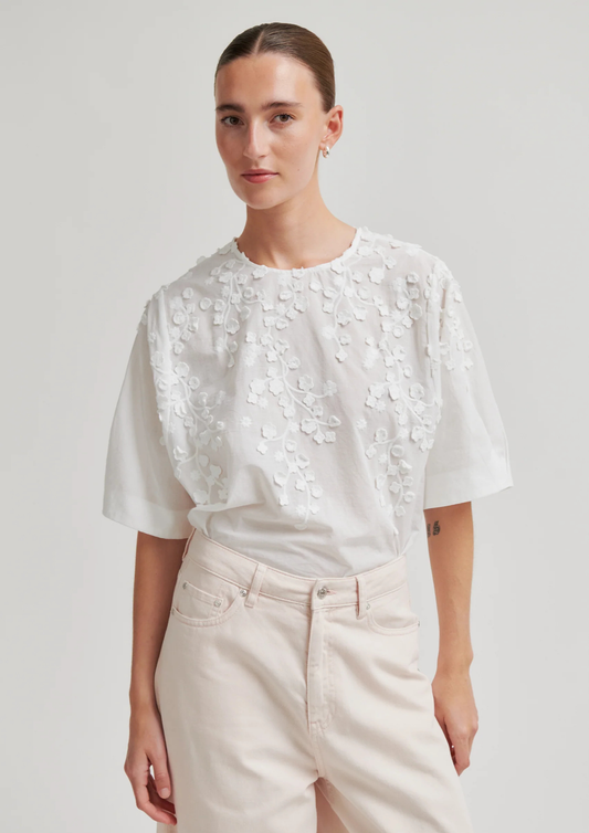 model wearing floral white blouse 