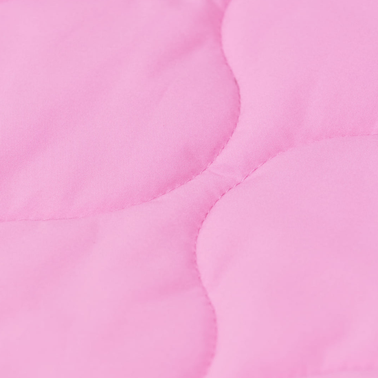 A close-up of a light pink quilted fabric with scalloped stitching.