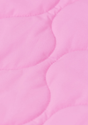 A close-up of a light pink quilted fabric with scalloped stitching.