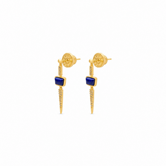 a pair of gold earrings with a blue lapis stone on a plain white background