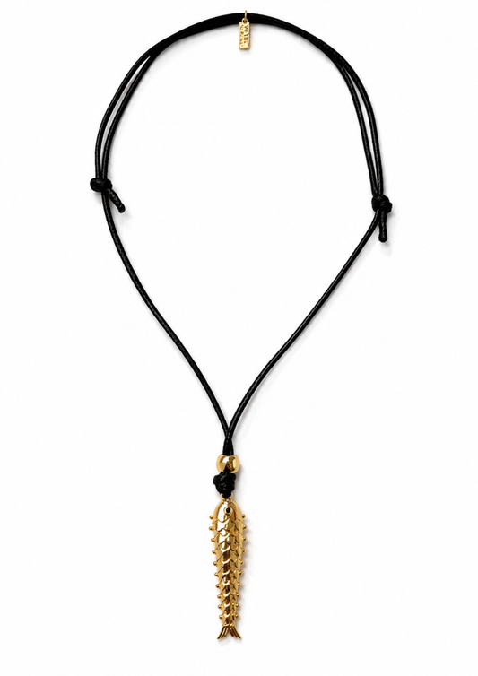 Product shot of black cord necklace with a gold fish pendant.