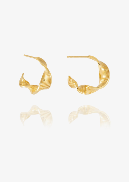 A pair of gold-toned twisted hoop earrings with a textured, ribbed surface, displayed on a clean white background with a soft reflection below.