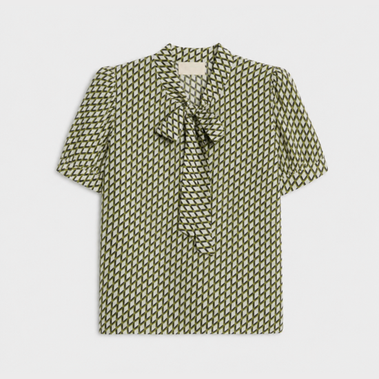flat lay of a green geometric blouse on a plain background
