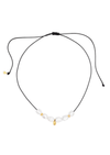 Necklace with black cord and small beads on a white background