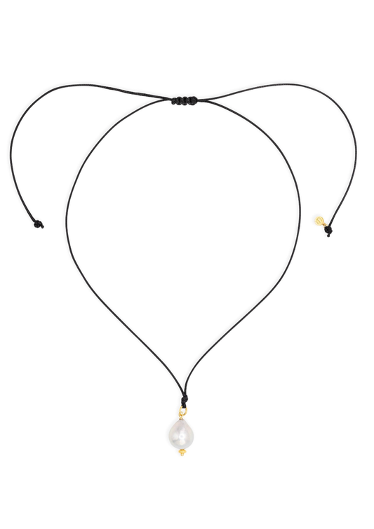 Black cord necklace with a pearl pendant on a white background