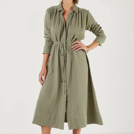 Woman wearing a green dress by Mondo Corsini with a white background