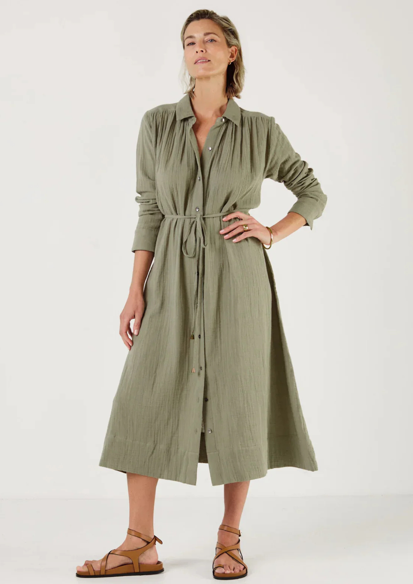 Woman wearing a green dress by Mondo Corsini with a white background