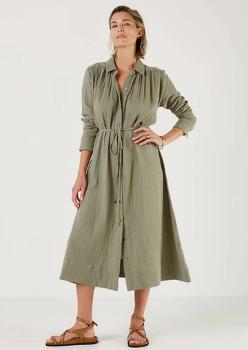 Woman wearing a green dress by Mondo Corsini with a white background