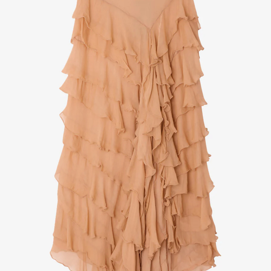 Tiered ruffle skirt in a shade of peach on a light gray background