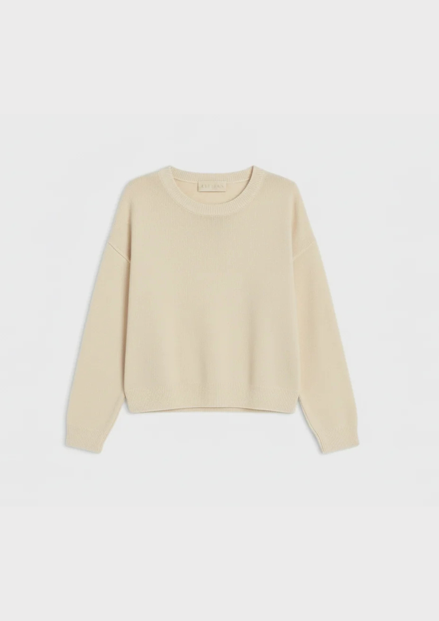 flat lay of beige crew neck jumper