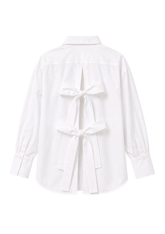 Classic white shirt with open back and bows on the white background