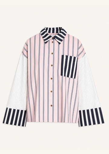 A long-sleeve button-up shirt with a pink and white vertical stripe body, contrasting black and white striped collar, chest pocket, and cuffs, displayed on a light cream background.
