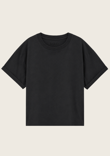 A plain black short-sleeve crewneck t-shirt displayed flat against a light beige background.