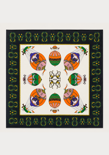 A square scarf featuring a symmetrical, colorful hot air balloon pattern on an off-white center field, surrounded by a black border with green and gold decorative motifs.