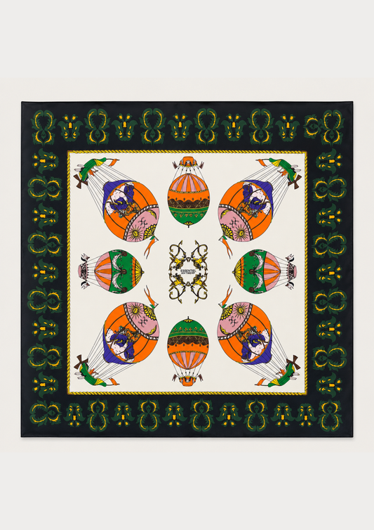 A square scarf featuring a symmetrical, colorful hot air balloon pattern on an off-white center field, surrounded by a black border with green and gold decorative motifs.
