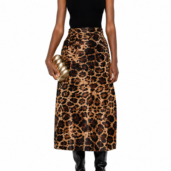 A model wearing a sleeveless black mock-neck top and a high-waisted leopard-print midi skirt, holding a gold metallic clutch, set against a plain white background.