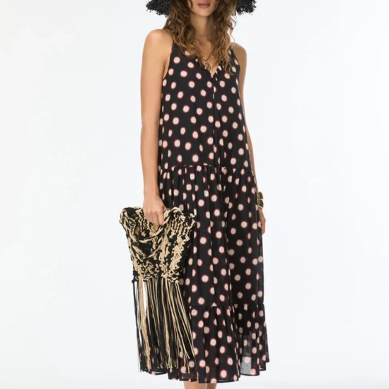 model wearing black dress with cream and red polka dots