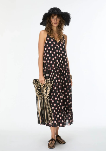 model wearing black dress with cream and red polka dots