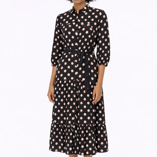 woman wearing black dress with white and red outlines circle pattern on white background