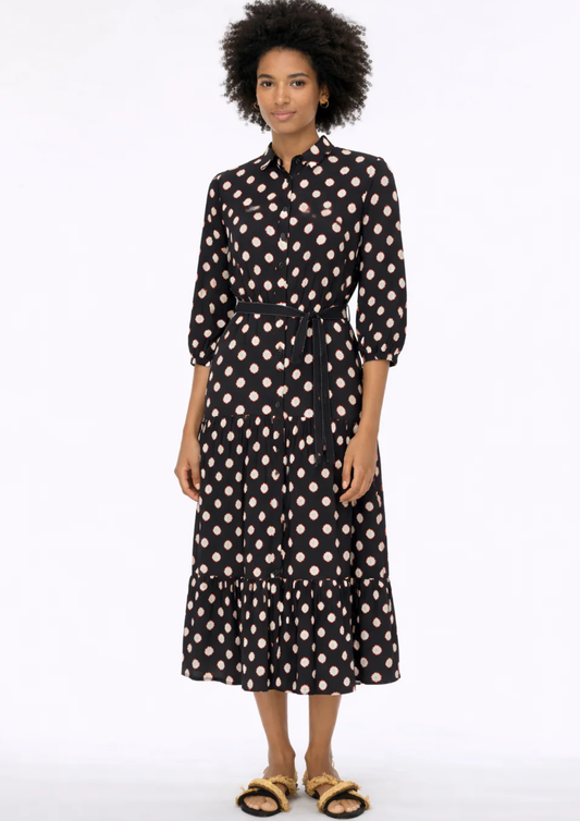 woman wearing black dress with white and red outlines circle pattern on white background
