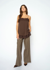 woman wearing brown lace cami and check trousers