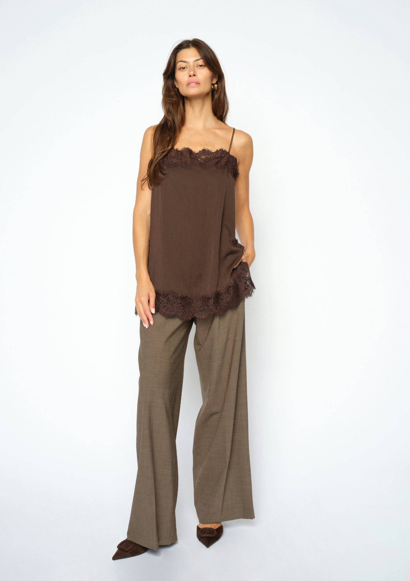 woman wearing brown lace cami and check trousers