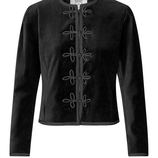 model wearing black leather trousers and a black velvet nepoleon style jacket with a plain background