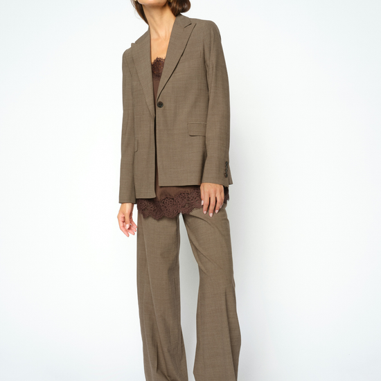 Woman wearing brown textured suit and brown lace cami