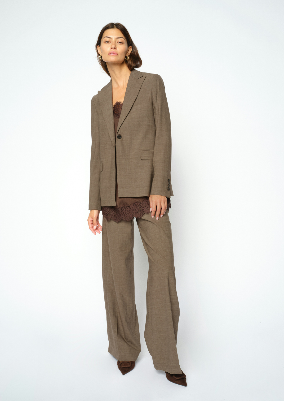 Woman wearing brown textured suit and brown lace cami