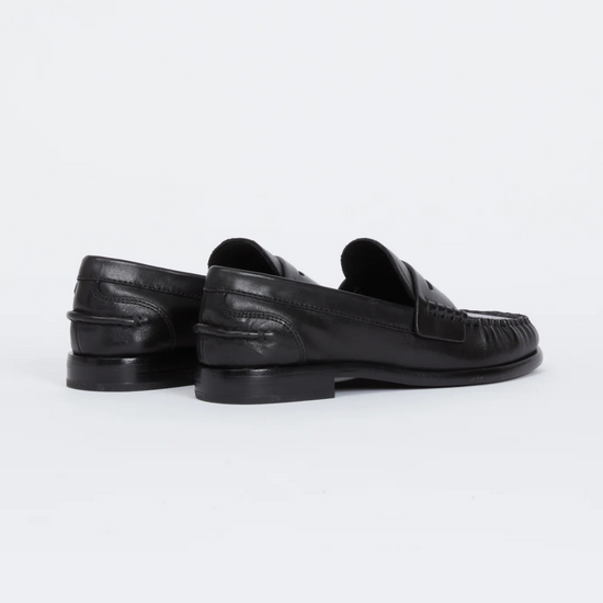 A pair of black leather penny loafers shown from the rear three-quarter view on a clean white studio background.