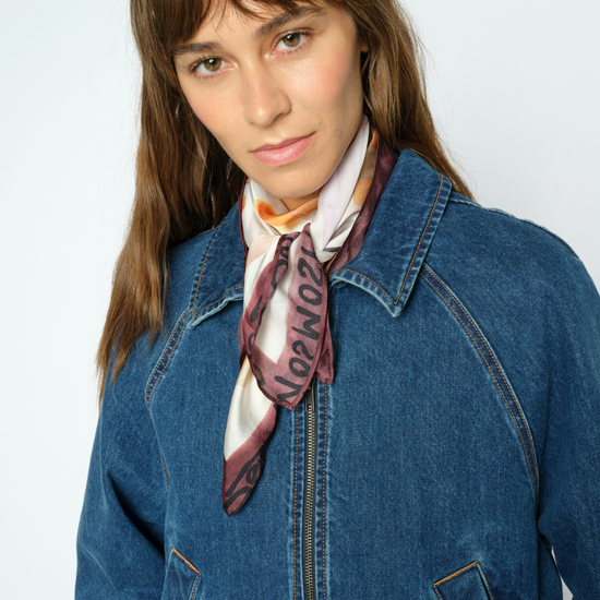Woman wearing Scarf with hands and faces with a denim jacket