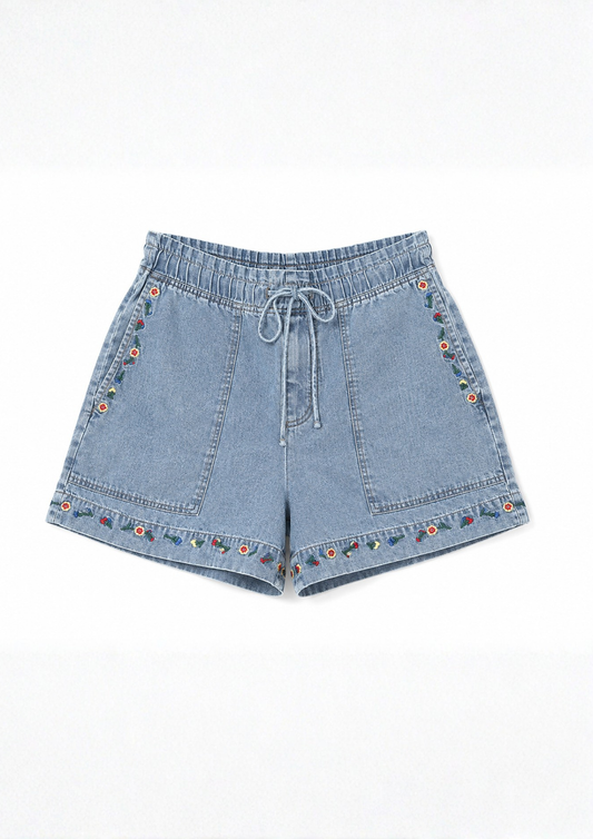 Blue denim shorts with floral embroidery on a white background
