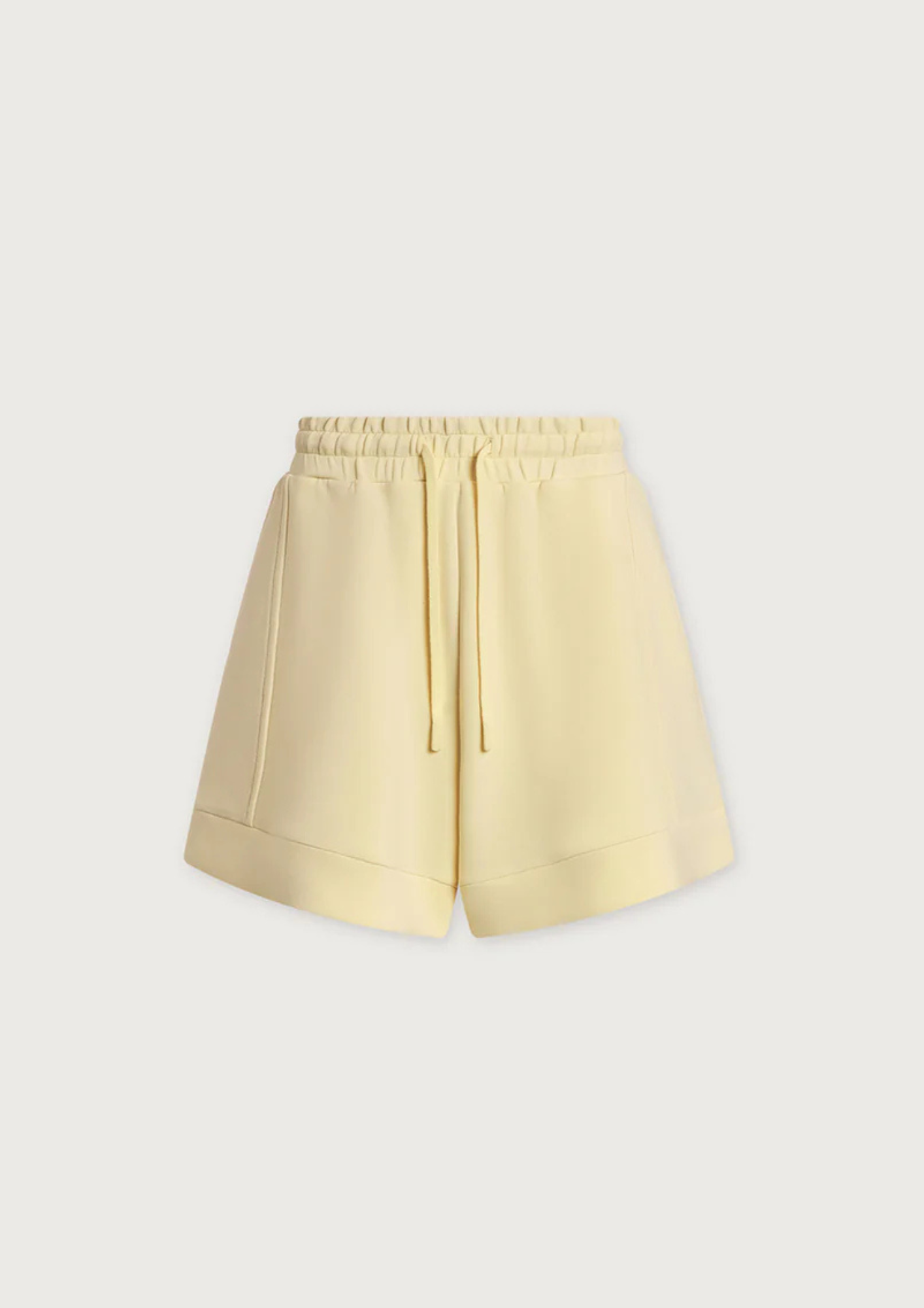 Light yellow shorts on a light gray background
