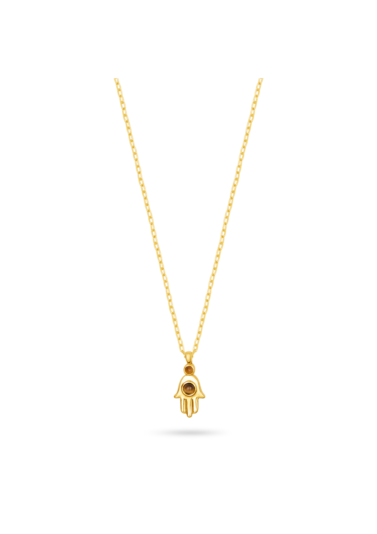A gold Hamsa hand pendant necklace with a small black eye detail, suspended from a delicate gold chain against a solid white background.