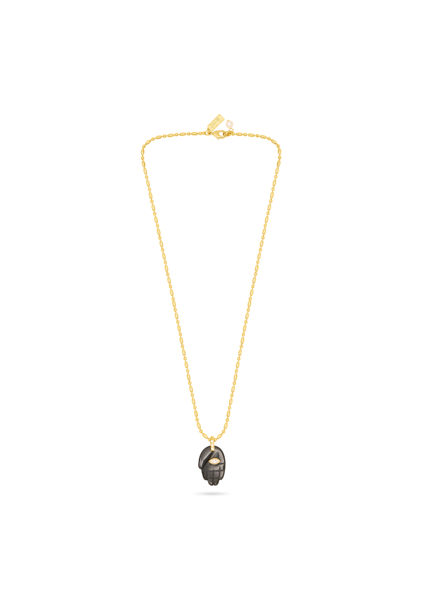 A delicate gold chain necklace featuring a small, dark metallic pendant with a textured, hammered finish, displayed against a solid white background.