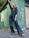 navy sequin jumpsuit with v neck, long sleeves and shoulder pads model shot