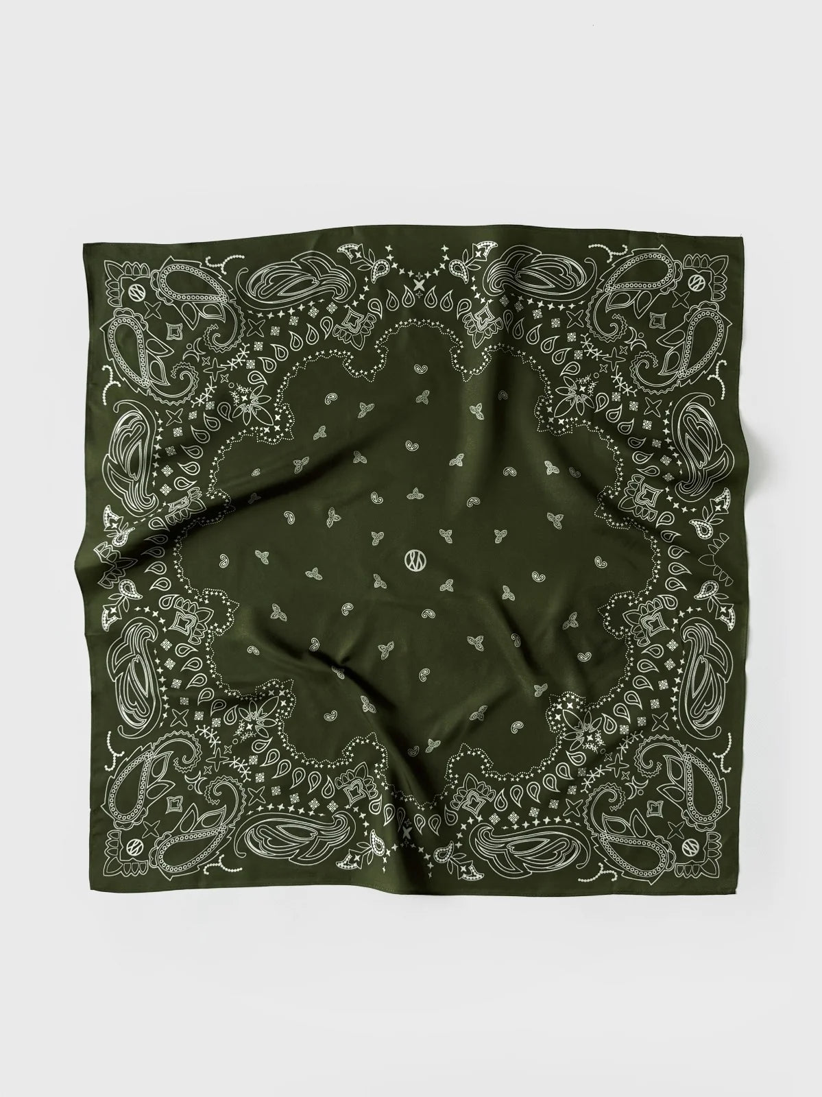 A green bandana with a white paisley and floral pattern, laid flat on a light gray background.