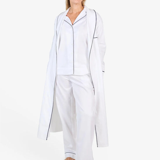 White herringbone organic cotton robe with navy trim long sleeves and front patch pocket